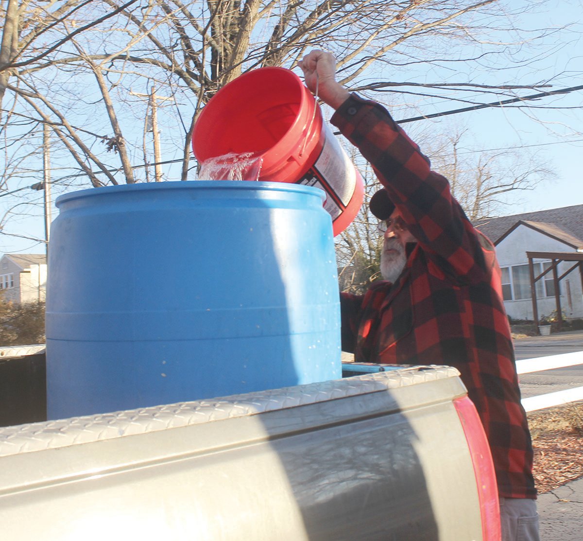 Allen Marrocco pours his sap into a large barrell.
